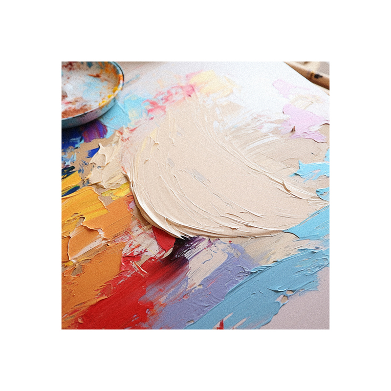 A paint palette on a table next to a paint brush.