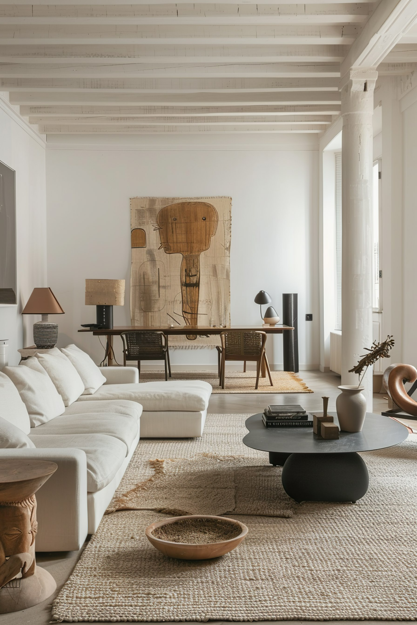 Modern living room with neutral tones, white sofa, wooden furniture, textured rug, and abstract art piece on the wall.