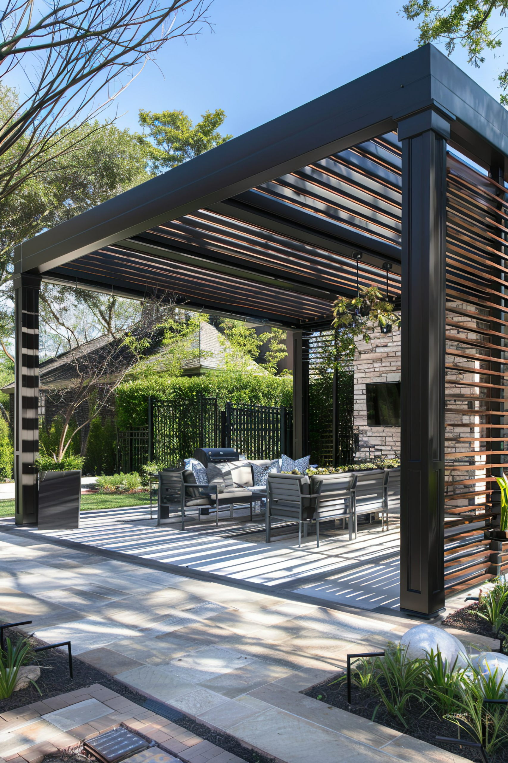 Modern outdoor patio with a pergola, furniture set, and neatly landscaped garden, showcasing contemporary exterior design.