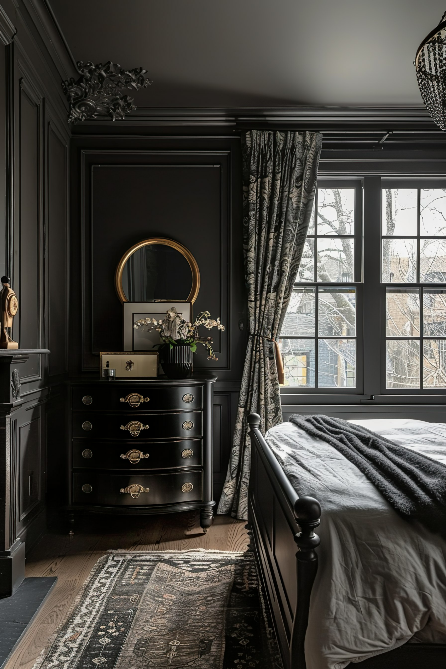 Elegant bedroom with dark walls and furniture, featuring a black dresser with round mirror, patterned curtains, classic bed, and ornate rug.